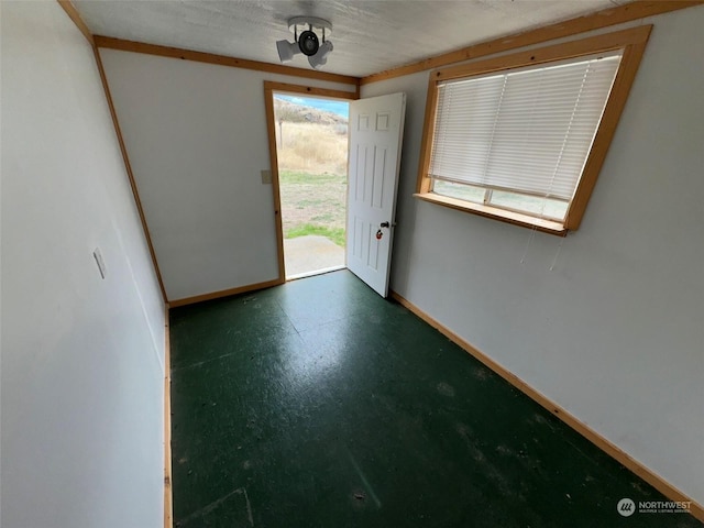 interior space featuring finished concrete flooring and baseboards