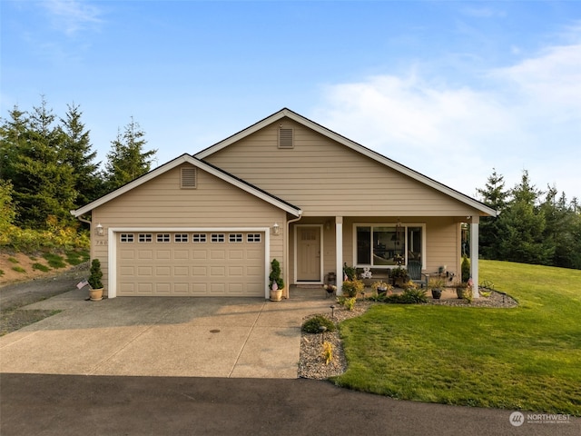 view of front of property with a garage, a front lawn, and covered porch