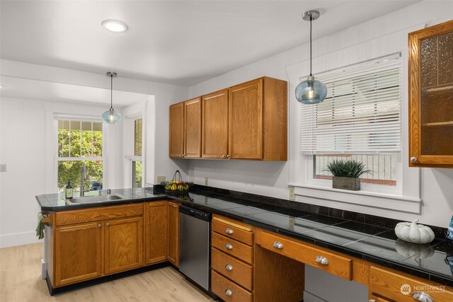 kitchen with light wood-type flooring, sink, kitchen peninsula, and stainless steel dishwasher