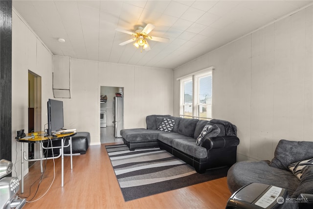 living room featuring ceiling fan and hardwood / wood-style flooring