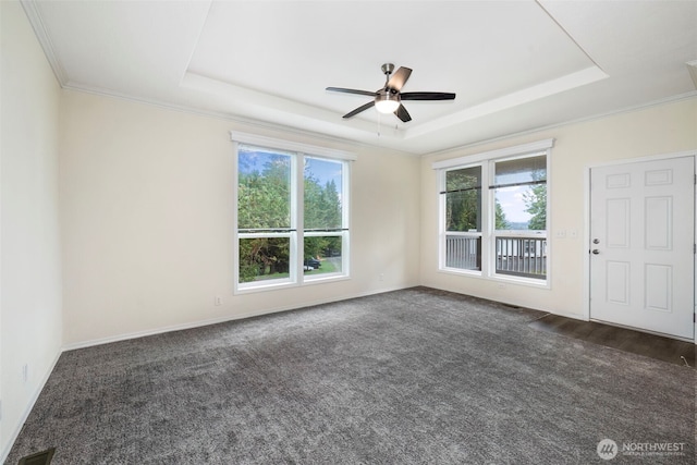 191 E Greenwood Ln, Shelton, WA 98584 - empty room with a raised ceiling, healthy amount of natural light, ceiling fan, crown molding, and dark carpet