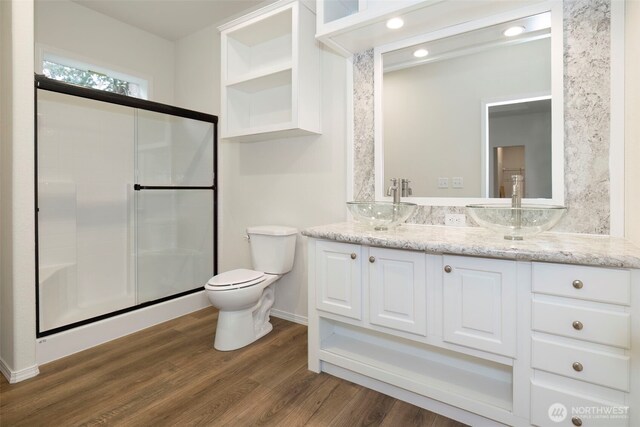 191 E Greenwood Ln, Shelton, WA 98584 - bathroom with toilet, double vanity, wood finished floors, a shower stall, and baseboards