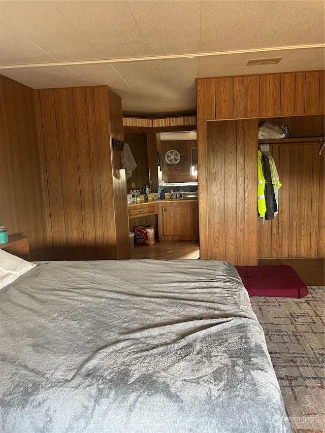 bedroom featuring wood walls