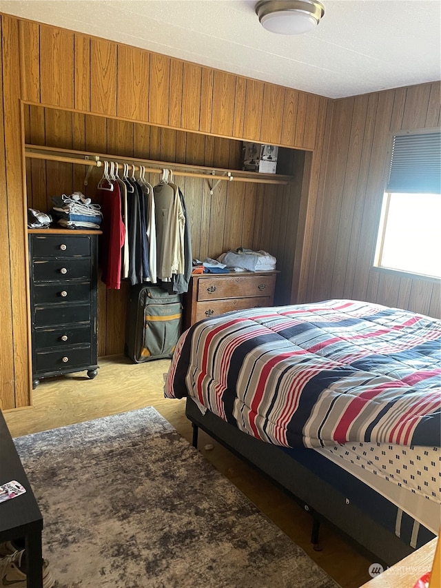 bedroom with wood walls