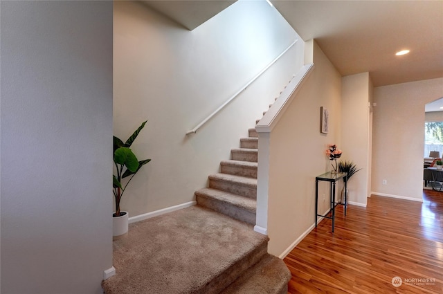 staircase featuring hardwood / wood-style flooring