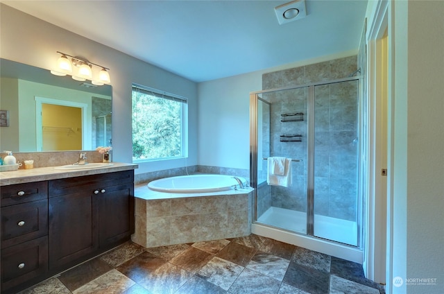 bathroom with vanity and independent shower and bath