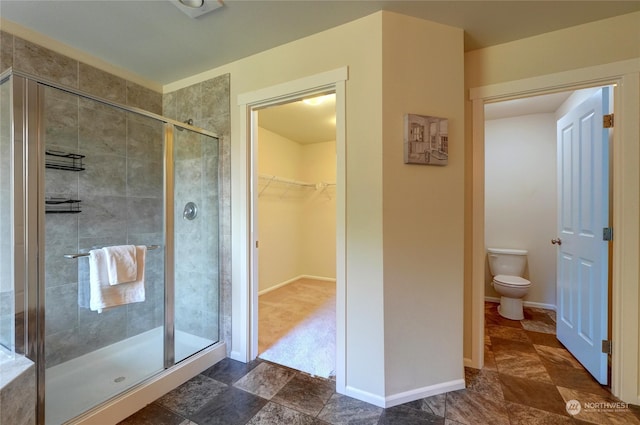 bathroom with toilet and walk in shower