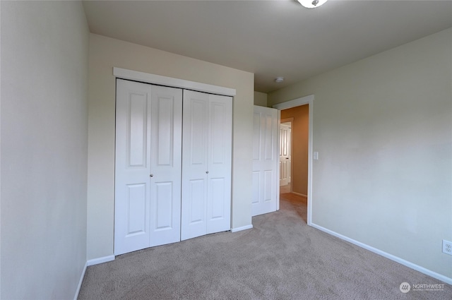 unfurnished bedroom with carpet floors and a closet