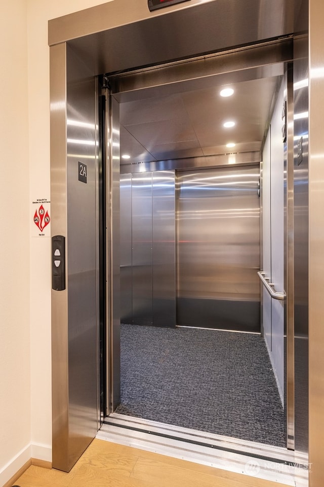 room details with elevator and carpet flooring