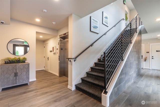 entrance foyer with light wood-type flooring and elevator