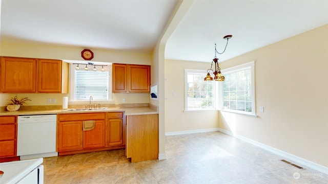 kitchen with dishwasher, decorative light fixtures, a chandelier, and sink