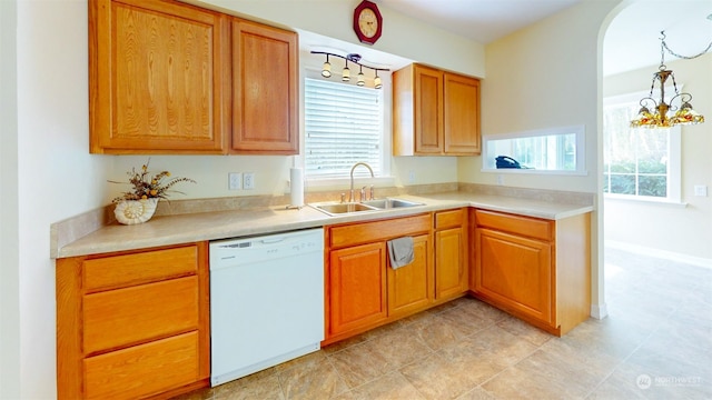 kitchen with dishwasher, hanging light fixtures, a healthy amount of sunlight, and sink