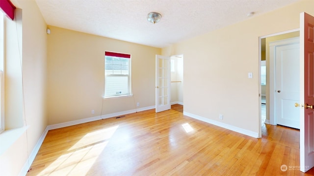 unfurnished bedroom featuring a textured ceiling and hardwood / wood-style floors