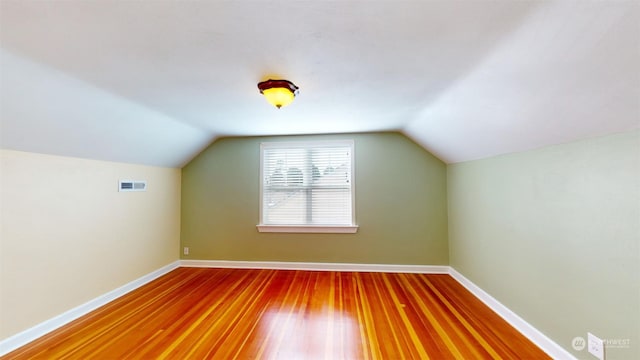 bonus room with vaulted ceiling and hardwood / wood-style flooring