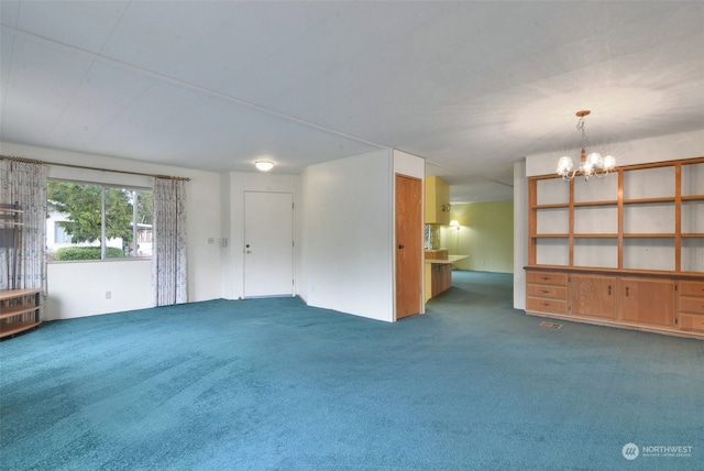 unfurnished living room featuring an inviting chandelier and carpet