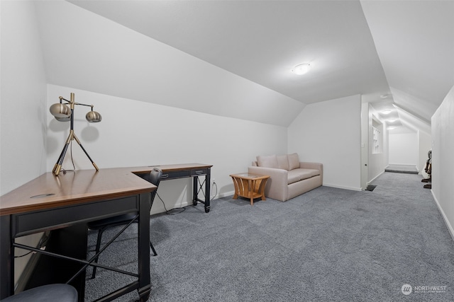 carpeted home office with lofted ceiling