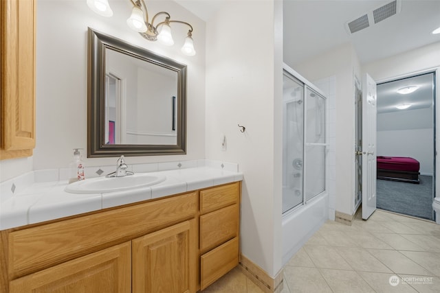 bathroom with shower / bath combination with glass door, vanity, and tile patterned floors