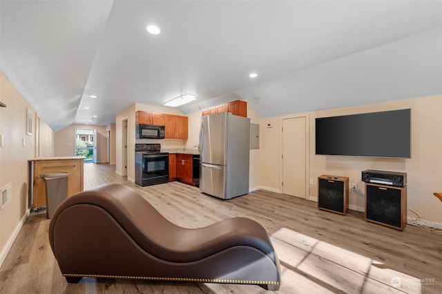 living room with light hardwood / wood-style flooring and lofted ceiling