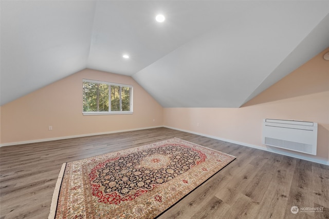 bonus room featuring light hardwood / wood-style flooring and vaulted ceiling