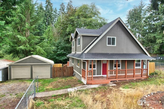 view of front of property with covered porch, an outbuilding, and a garage