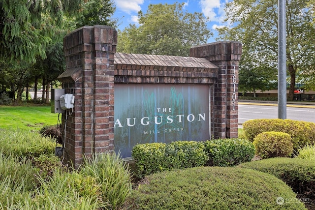 community sign featuring a lawn