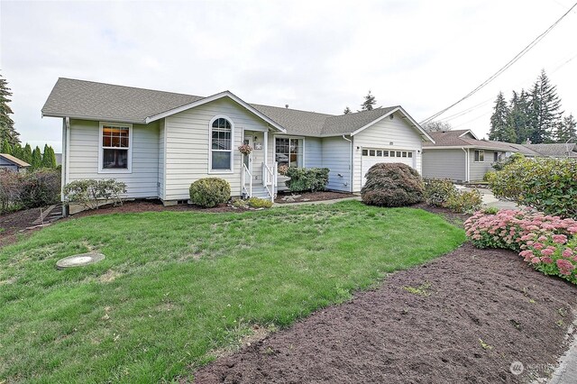 ranch-style home featuring a front yard and a garage