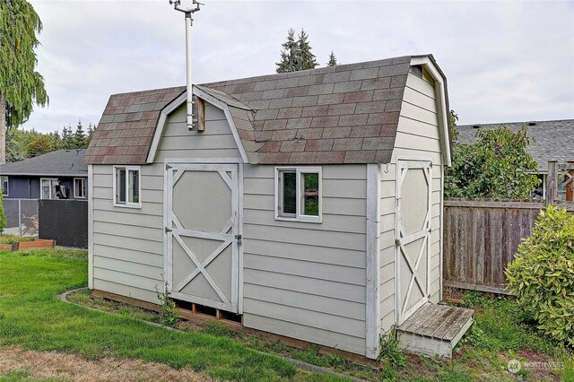 view of outdoor structure featuring a lawn