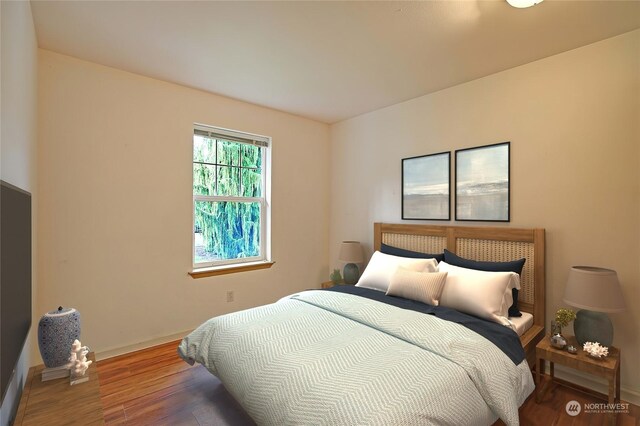 bedroom with hardwood / wood-style floors