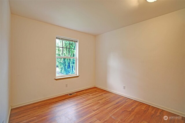 spare room with light hardwood / wood-style flooring