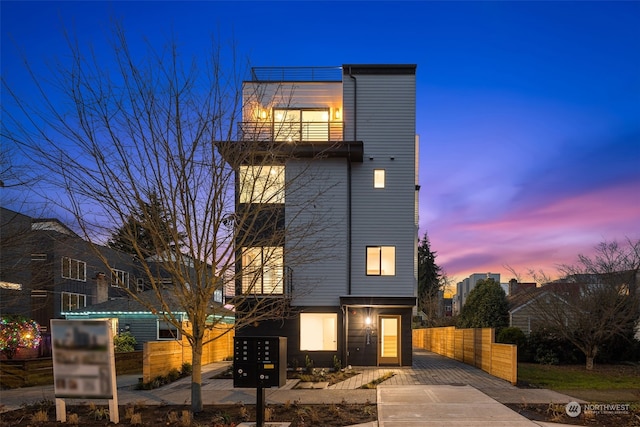 view of front of house featuring a balcony