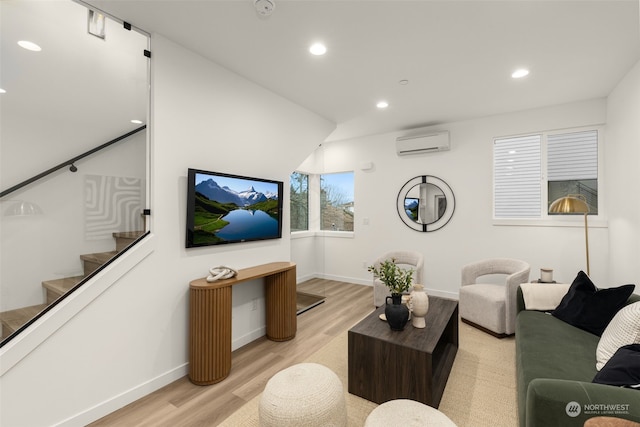 living room with light hardwood / wood-style floors and a wall mounted AC