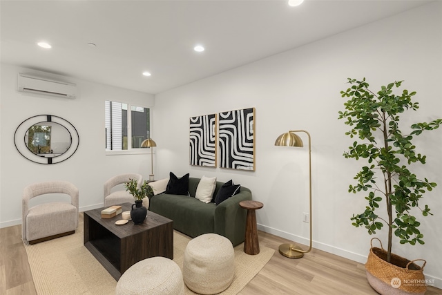 living room with light hardwood / wood-style floors and an AC wall unit