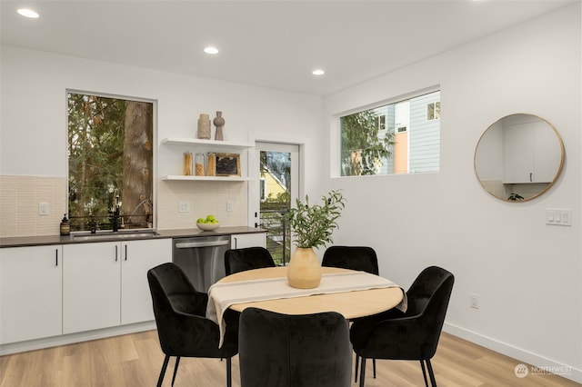 dining room featuring light hardwood / wood-style flooring and sink