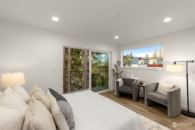 bedroom with light wood-type flooring and access to outside