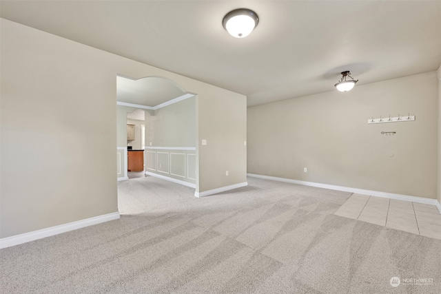 unfurnished room with light carpet and ornamental molding