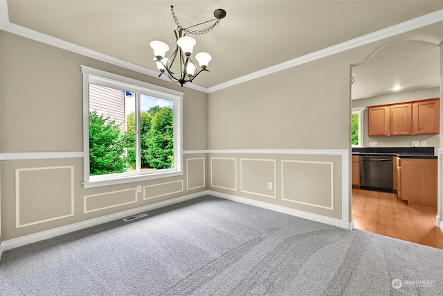 unfurnished dining area featuring crown molding, hardwood / wood-style floors, and an inviting chandelier