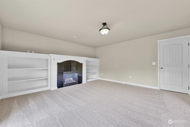 unfurnished living room featuring carpet floors