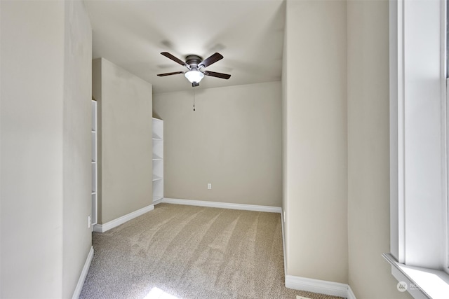 empty room with ceiling fan and light colored carpet