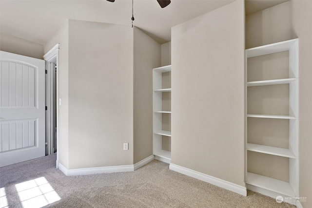 interior space featuring light colored carpet and ceiling fan