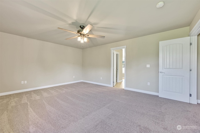 carpeted empty room featuring ceiling fan