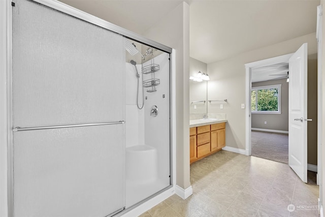 bathroom featuring vanity, ceiling fan, and an enclosed shower