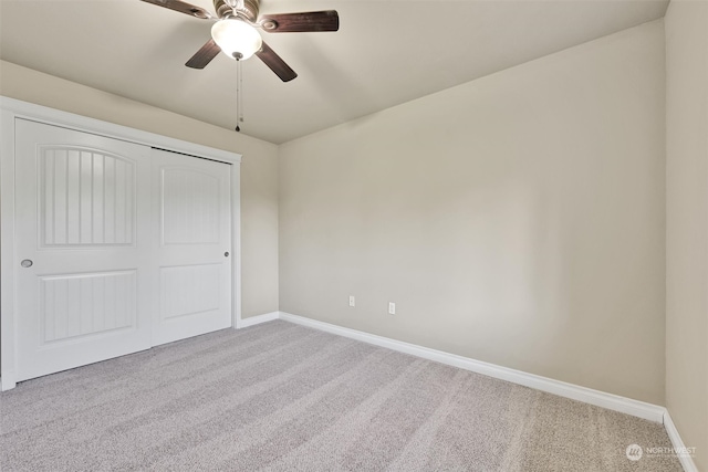 unfurnished bedroom with light carpet, ceiling fan, and a closet