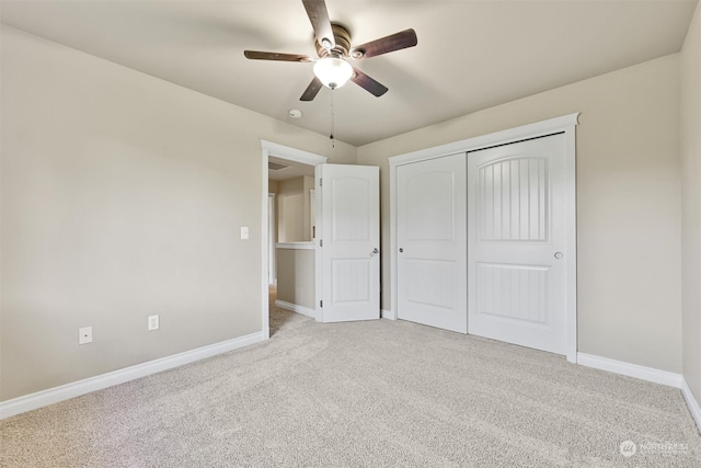 unfurnished bedroom with light carpet, ceiling fan, and a closet