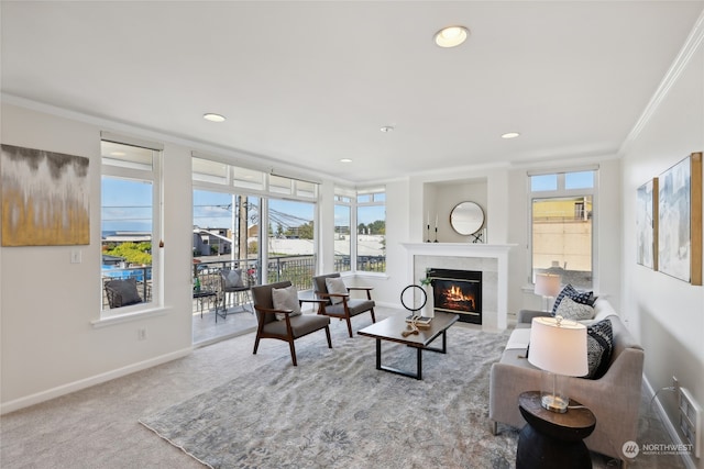 living room featuring light colored carpet, ornamental molding, and a tile fireplace