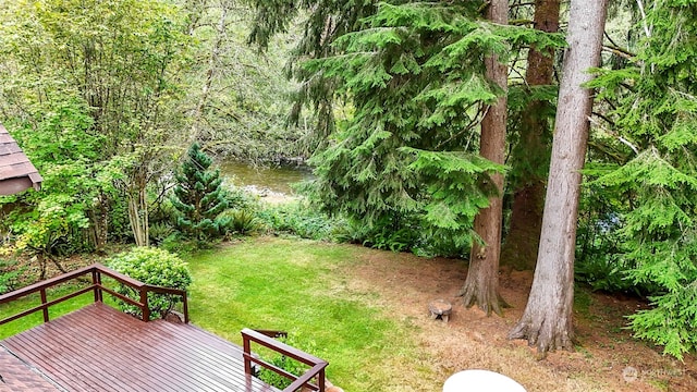 view of yard with a deck with water view