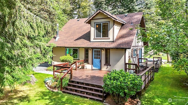 back of house with a lawn and a deck