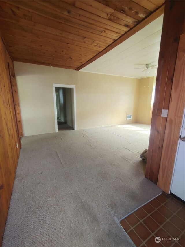 carpeted empty room featuring wooden ceiling and ceiling fan