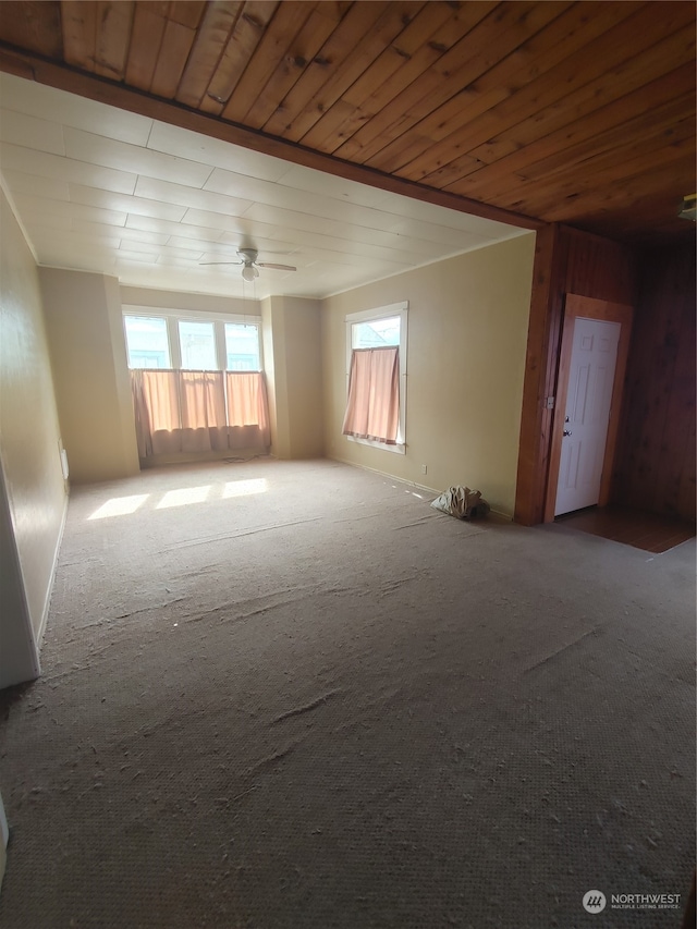 spare room featuring ceiling fan, wood ceiling, and carpet