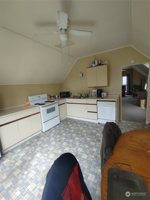 kitchen with lofted ceiling, white appliances, dark carpet, and ceiling fan