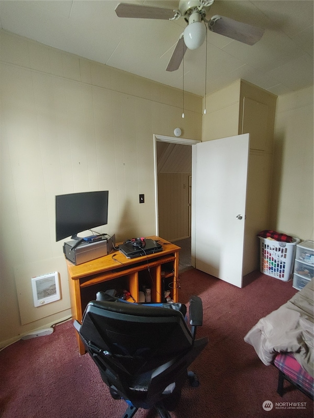 office space with dark colored carpet and ceiling fan